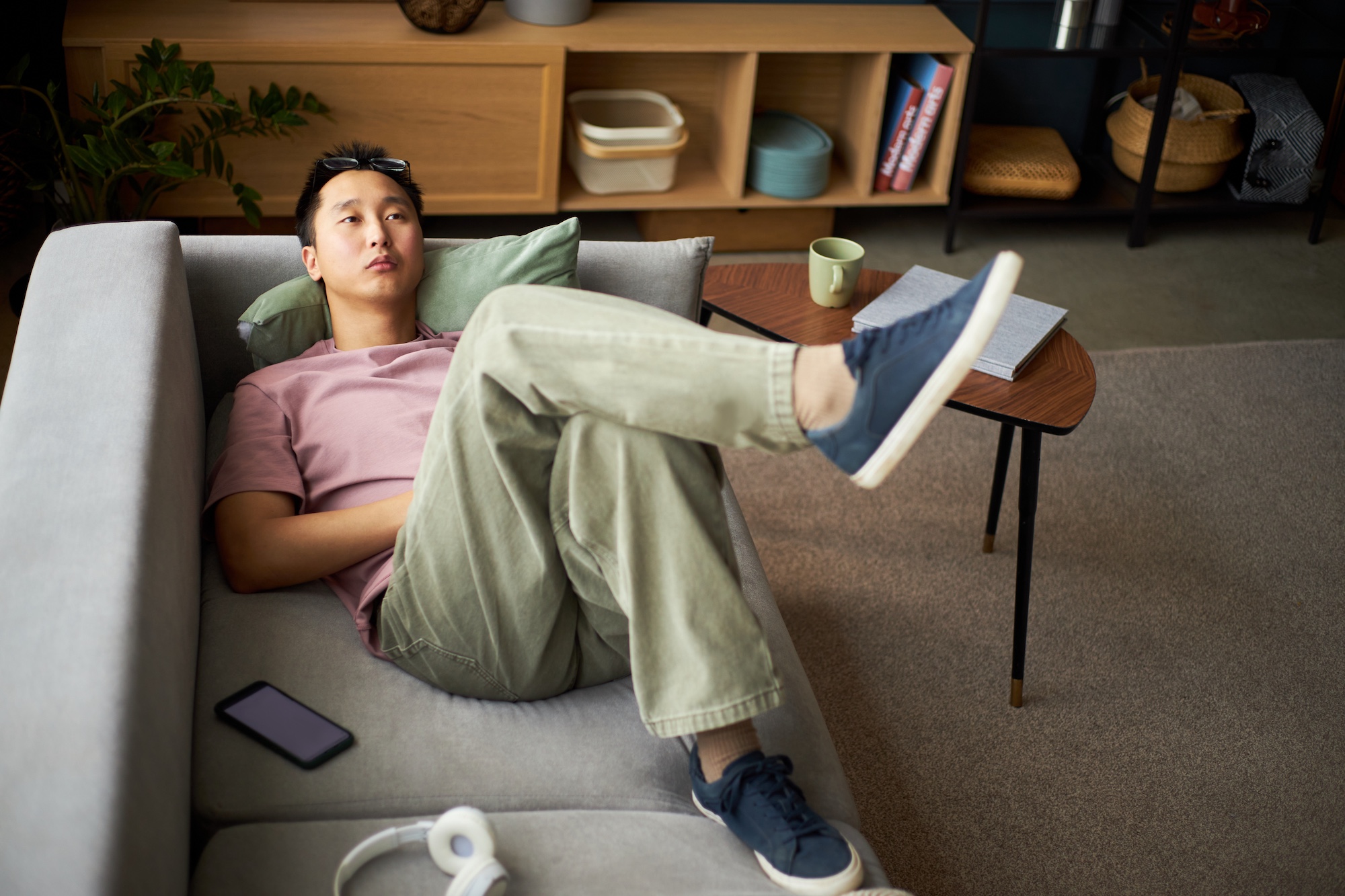 Man laying on couch in thought